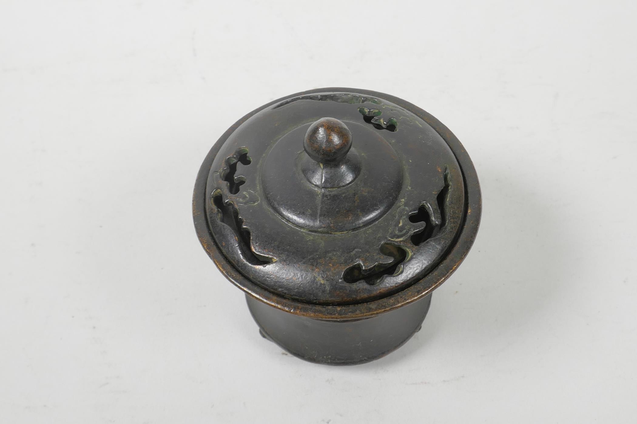 A Chinese bronze burner and cover of waisted form, impressed 4 character seal mark to base, 3½" high - Image 2 of 3