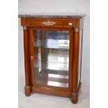 A C19th French Empire style mahogany display cabinet, with a marble top, mirrored back and