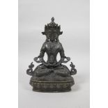 A Sino-Tibetan bronzed metal figure of Buddha seated in meditation on a lotus throne, 9" high