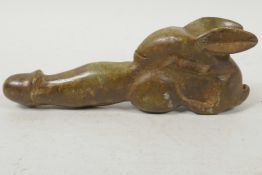 A carved hardstone phallic ornament with stylised rabbit base, 5" long