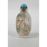 A Chinese reverse decorated snuff bottle depicting birds amongst flowers and gourds, 3½" high