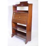 An Edwardian inlaid walnut open bookcase with fall front, fitted with pigeon holes and two pen