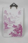 A Chinese porcelain panel decorated with a puce enamelled riverside landscape scene, 10" x 14½"