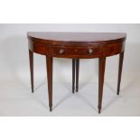 A C19th inlaid mahogany demilune fold over card table, with single frieze drawer on square tapered