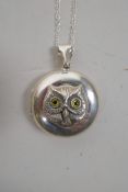 A 925 silver locket and chain, decorated with an owl's head, 1½" drop