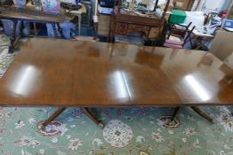 A good Regency style twin pedestal dining table with extra leaf, raised on turned column columns and