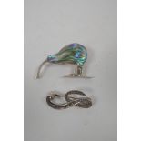 A sterling silver brooch set with abalone in the form of a kiwi, and another silver brooch set