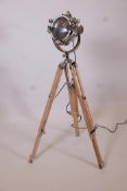 A replica chrome plated spotlight style standard lamp, on a wood and metal tripod, 42" high minimum