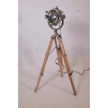 A replica chrome plated spotlight style standard lamp, on a wood and metal tripod, 42" high minimum