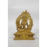 A Tibetan gilt bronze of Buddha, seated on a throne and holding a vajra, 7" high
