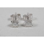 A pair of diamond stud earrings, approximately 1.1ct, on white gold posts