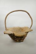 A wood and coconut husk petal shaped basket, 18" high