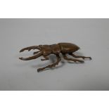 A Japanese Jizai style bronze of a beetle, indistinct impressed marks to base, 3" long