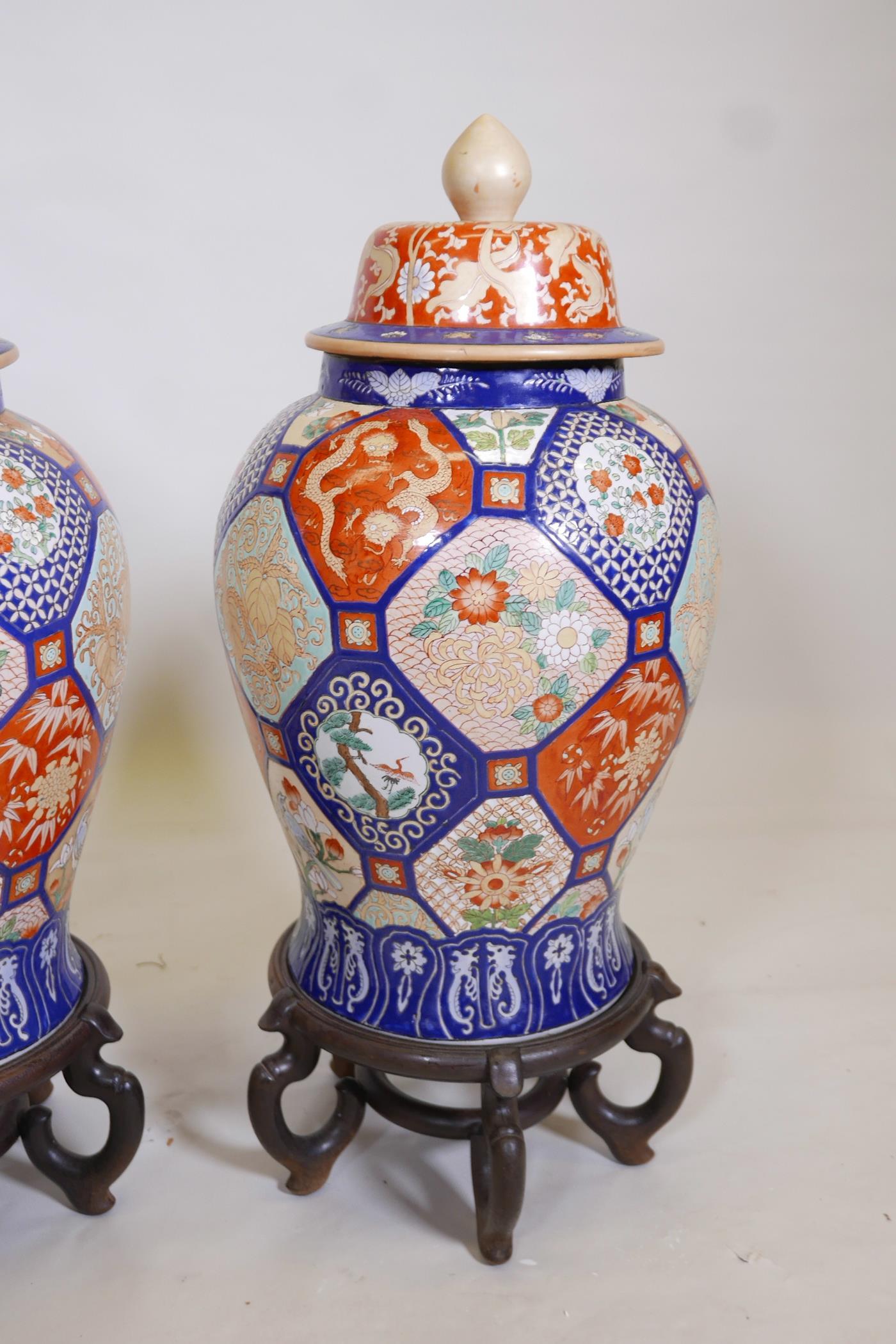 A pair of Oriental ceramic jars and covers, decorated with bright enamels in the Imari style, with - Image 2 of 5