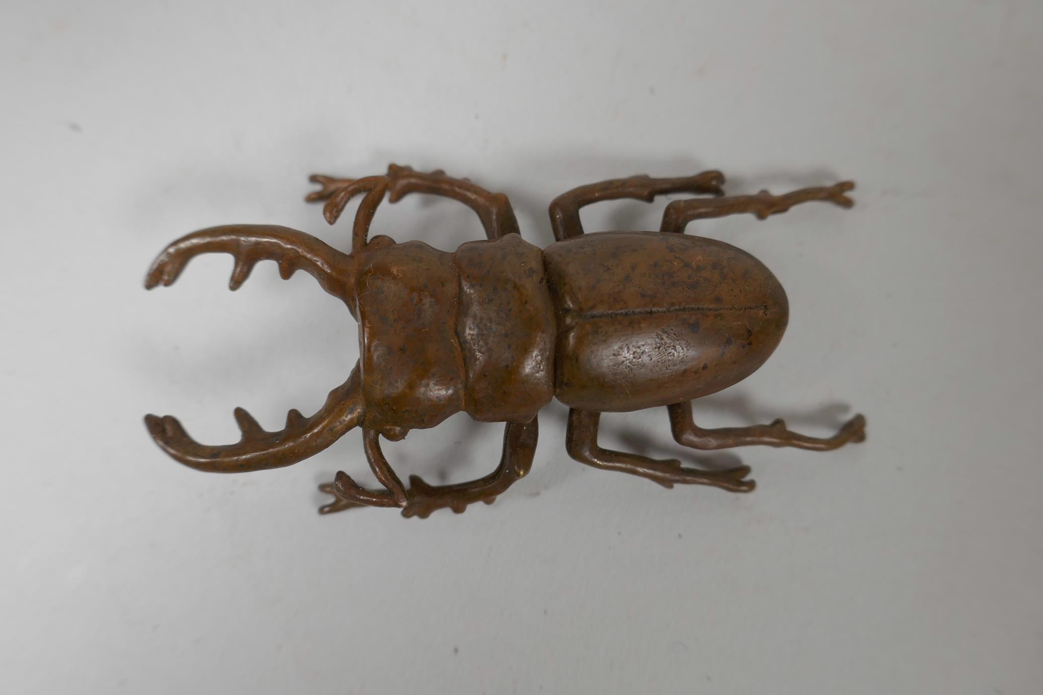 A Japanese Jizai style bronze of a beetle, indistinct impressed marks to base, 3" long - Image 2 of 3