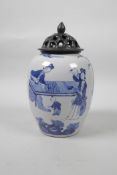 A Chinese blue and white porcelain jar with an associated pierced wood cover, decorated with