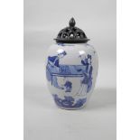 A Chinese blue and white porcelain jar with an associated pierced wood cover, decorated with