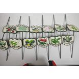 A set of twelve painted cast metal garden/allotment plant markers, 4½" wide