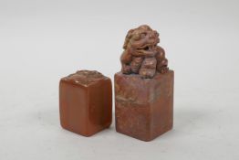 A Chinese red soapstone seal with carved kylin decoration, and another amber soapstone seal with