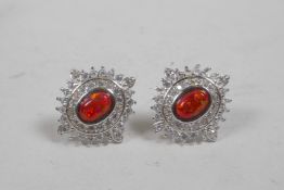 A pair of silver earrings set with an amber opalite stone encircled by cubic zirconium