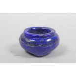 A Chinese carved lapis lazuli brush wash on tripod feet, 2½" diameter