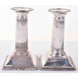 A pair of Victorian squat Corinthian column candlesticks, by William Hutton, London 1881