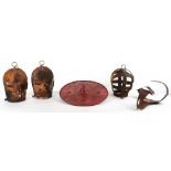 A box containing two reproduction wrought iron medieval scolds bridle masks (witches bridle)