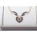 A 9ct gold and sapphire necklace with earrings