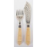 ^A pair of silver and ivory handle fish servers