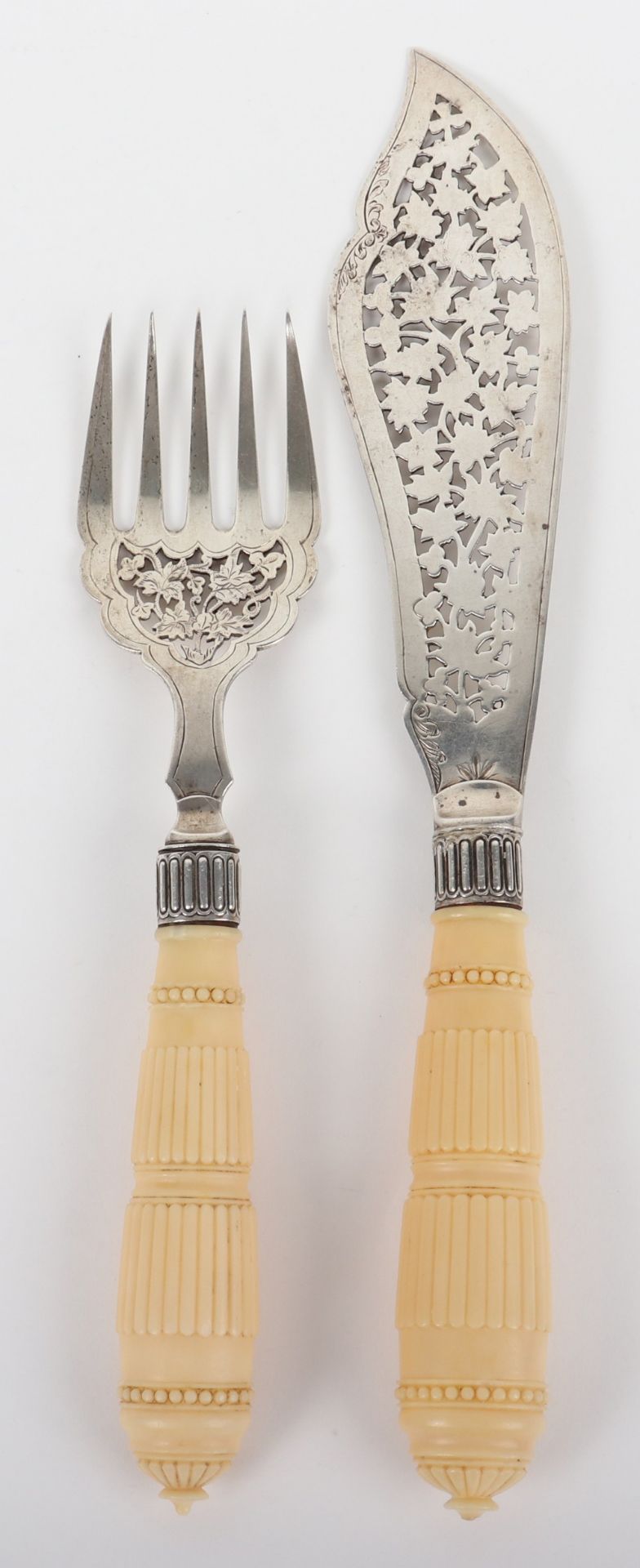 ^A pair of silver and ivory handle fish servers