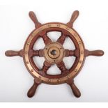 An early 20th century oak and brass ships wheel