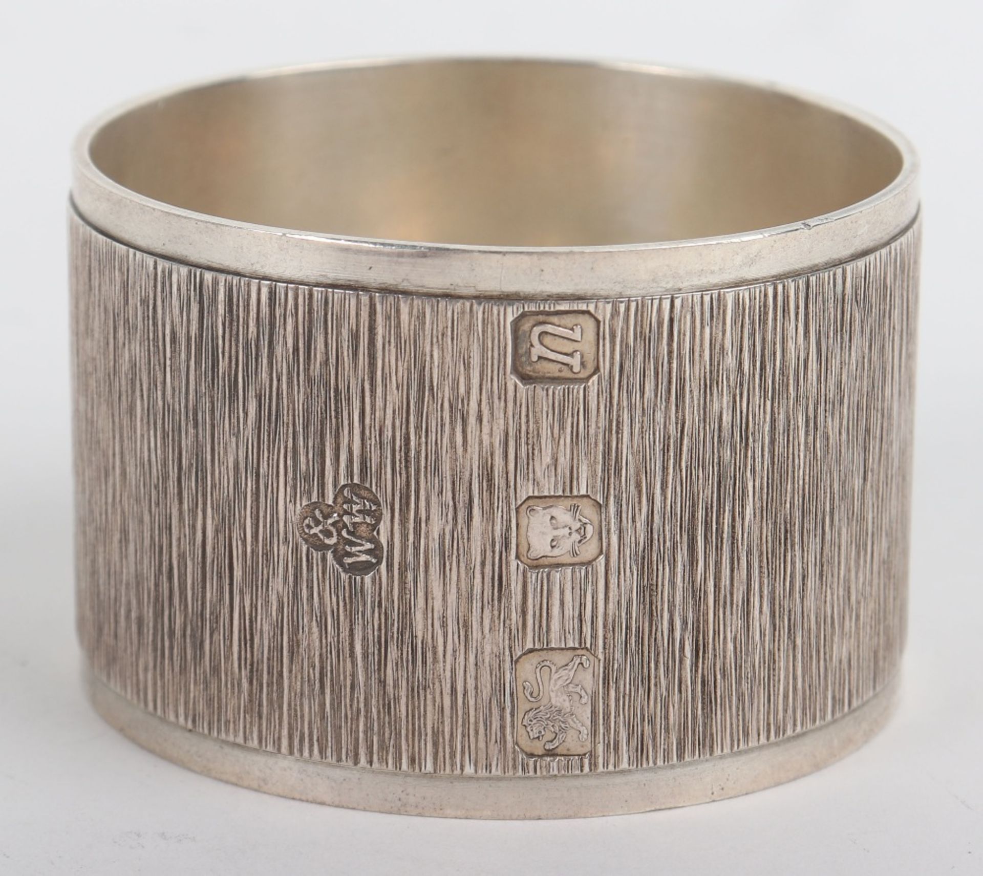 A modern silver napkin ring with textured body, Wakely & Wheeler, London modern