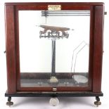 A Townson & Mercer set of scales, in glass, oak and mahogany case