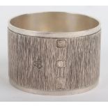 A modern silver napkin ring with textured body, Wakely & Wheeler, London modern