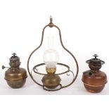 Two oil lamps, one with Campe Veritas badge