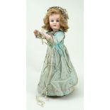 A Henri Rostal Mon Trésor bisque head musical pull-along doll, French circa 1914,