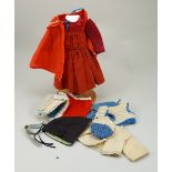 A good original red dolls dress, cape, bonnets and doll clothing,