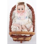 Miniature all-bisque baby doll in pram,