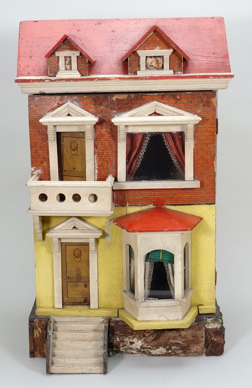 A painted wooden and paper lithographed dolls house, English circa 1900,