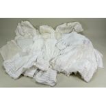 A good selection of white cotton dolls dresses and underclothes,