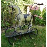 Gamage’s child’s push along wooden painted toy horse and dolls pram, circa 1900,