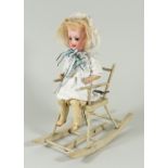A sweet mechanical toy Doll seated in clockwork rocking chair, German circa 1905,