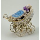 Miniature painted soft metal pram and doll, German circa 1890,