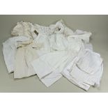 A good selection of white cotton dolls dresses, christening gowns and underclothes,