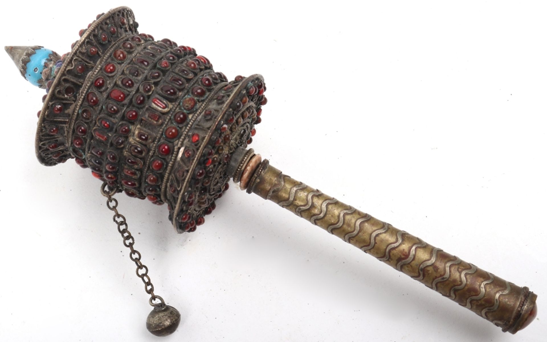 A Buddhist Tibetan brass and white metal prayer wheel, with prayer scroll within