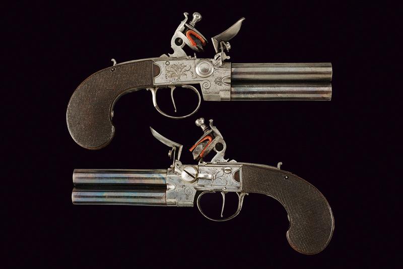 A pair of over and under barrelled flintlock pocket pistols