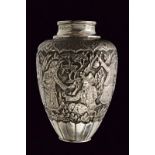 A silver chiselled vase