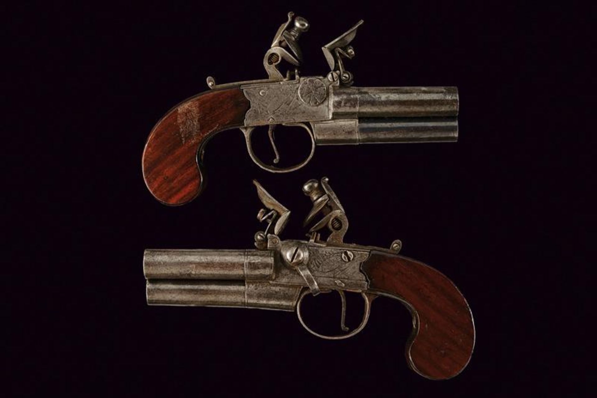 A rare pair of three barrelled flintlock pocket pistols by Parker Holborn
