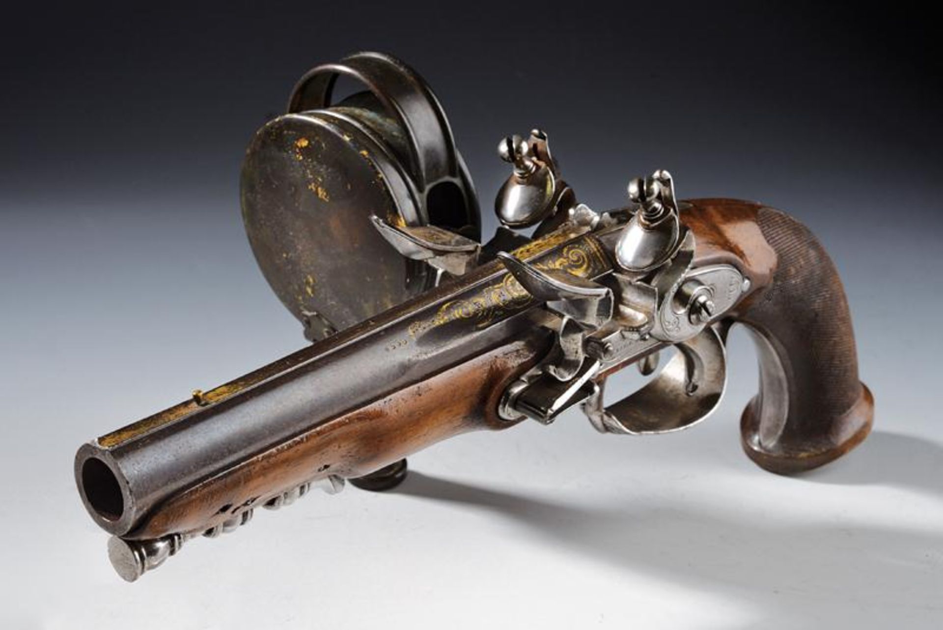 An extremely rare officer's flintlock pistol with lantern by Regnier