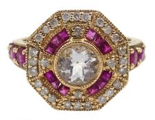 Gold ruby and diamond surround octagon dress ring, set with a central pale blue stone,